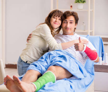 The loving wife looking after injured husband in hospitalの写真素材