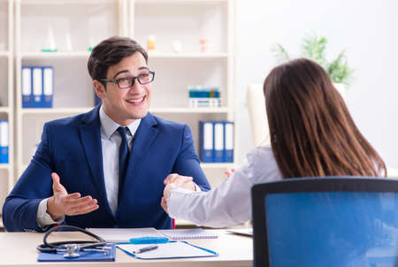 Man signing medical insurance contractの写真素材