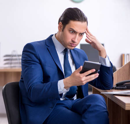 Young handsome businessman working in the officeの写真素材