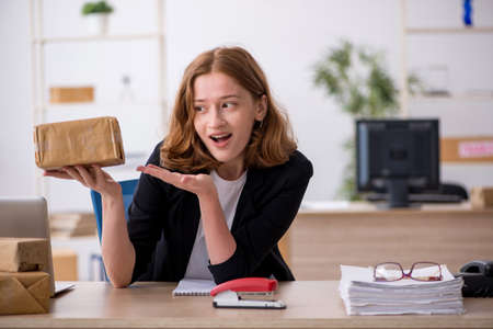 Young woman working in box delivery serviceの写真素材