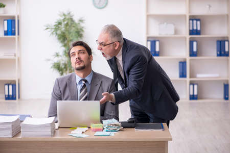 Two male employees in bullying conceptの写真素材