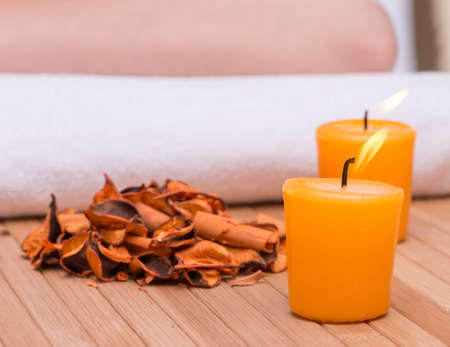 Spa concept with candles and dry leavesの写真素材