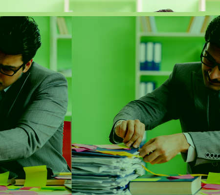 Businessman unhappy with many conflicting priorities sitting inの写真素材