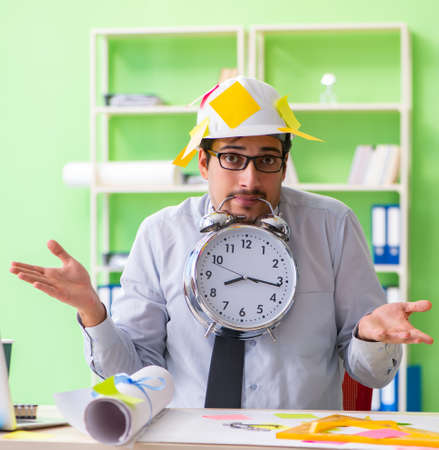 Male engineer working on new project with many conflicting priorの写真素材