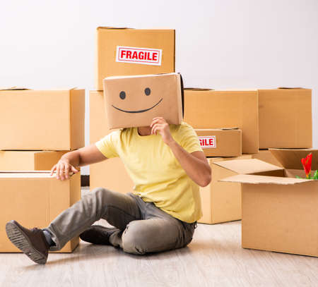 The happy man with box instead of his headの写真素材