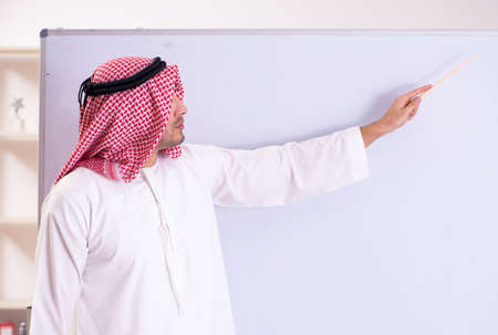 The arab teacher in front of whiteboardの写真素材