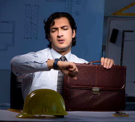 The young construction architect working on project at nightの写真素材