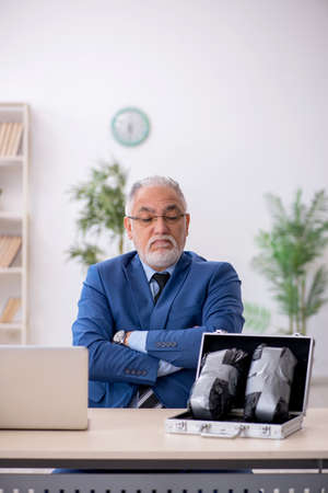 Old male employee in remuneration conceptの写真素材