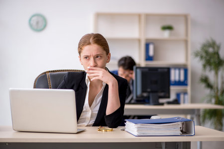 Two colleagues working in the officeの写真素材