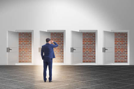 Businessman facing no exit with brick doorの写真素材