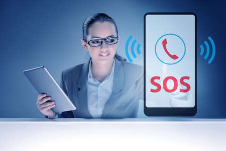 Businesswoman pressing SOS button in case of danger