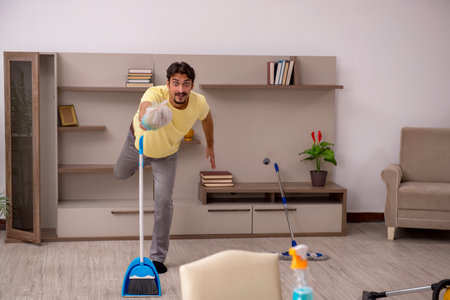 Young man doing housework at homeの写真素材
