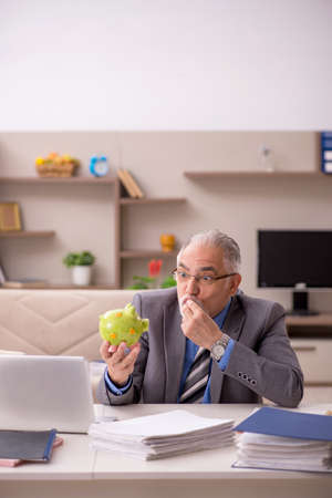 Old male employee in retirement concept during pandemicの写真素材