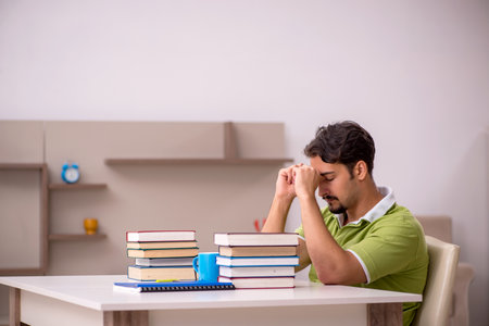 Young male student studying at homeの写真素材