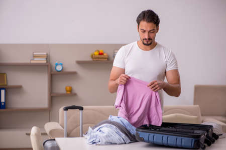 Young man preparing for trip at homeの写真素材