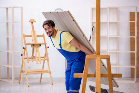 Young male carpenter working at homeの写真素材