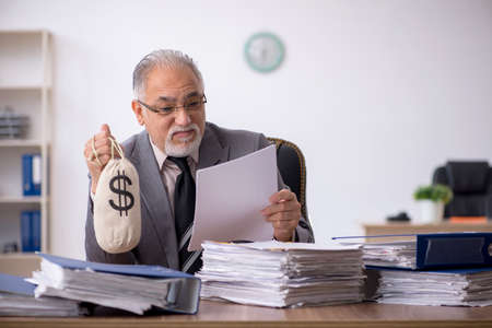 Old male employee in remuneration conceptの写真素材