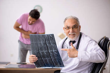 Young male patient visiting old male doctor radiologist