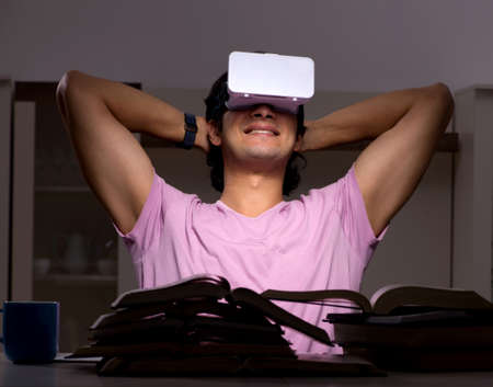 The male student with virtual glasses late at home