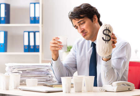 The young employee addicted to coffeeの写真素材