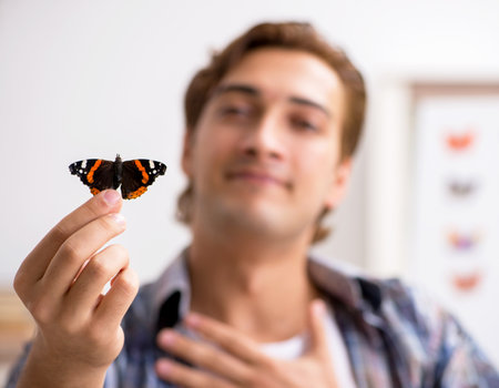 The student entomologist studying new species of butterfliesの写真素材