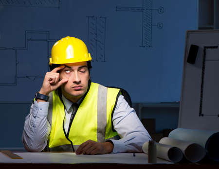 The young construction architect working on project at night