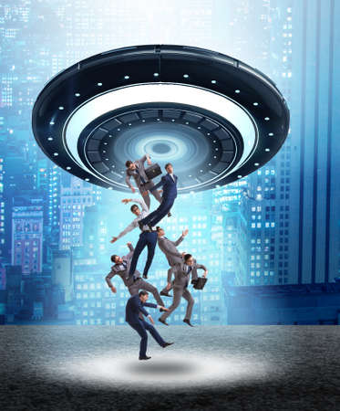 The flying saucer abducting young businessmanの写真素材