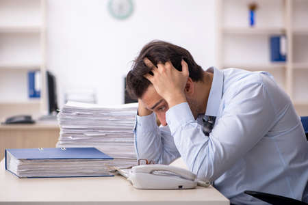 Young male employee working in the officeの写真素材