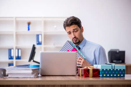 Young male employee celebrating birthday at workplaceの写真素材