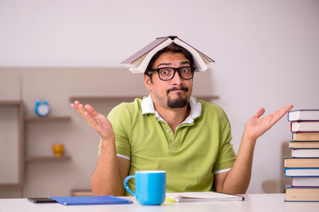 Young male student studying at homeの写真素材