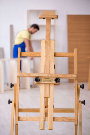 Young male carpenter working at workshopの写真素材
