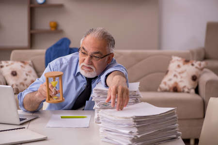Old male boss working from home during pandemic