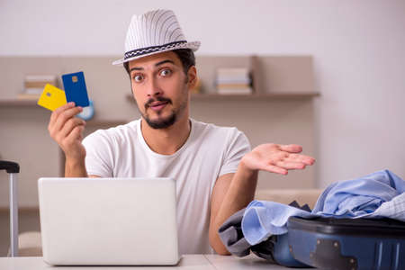 Young man preparing for trip at homeの写真素材