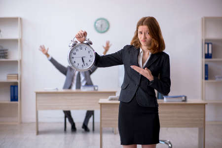 Two colleagues working in the office in time management conceptの写真素材