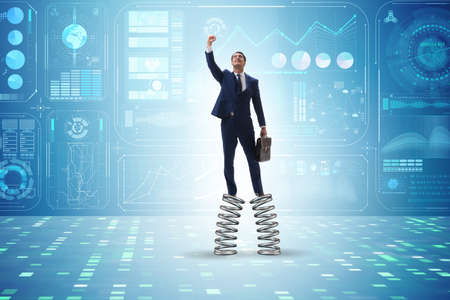 Businessman jumping high on springs