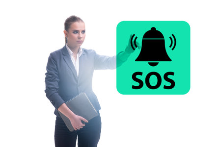 Businesswoman pressing SOS button in case of dangerの写真素材
