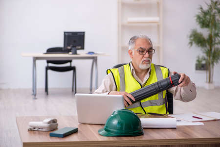 Old male architect working in the officeの写真素材