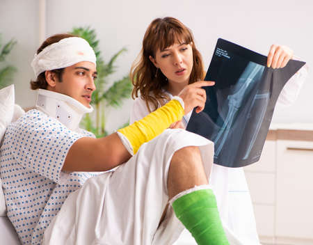 The young doctor examining injured patient