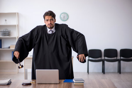 Young male judge working in the courthouseの写真素材