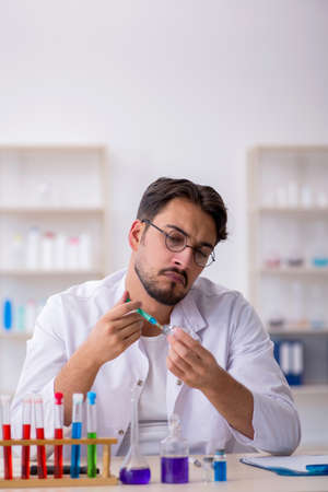 Young male chemist working at the labの写真素材