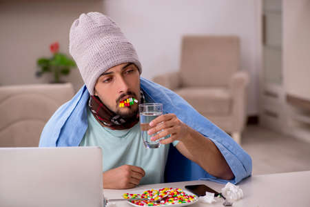 Young sick man suffering at home