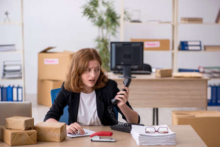 Young woman working in box delivery serviceの写真素材