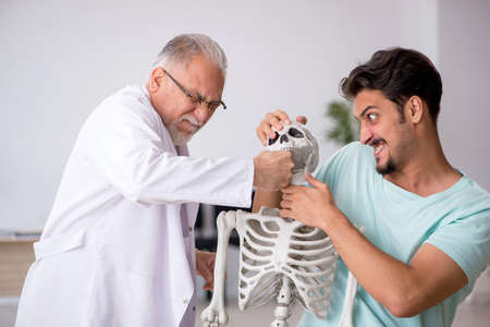 Young male patient visiting old male doctor