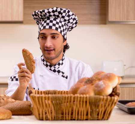 Young male baker working in kitchen