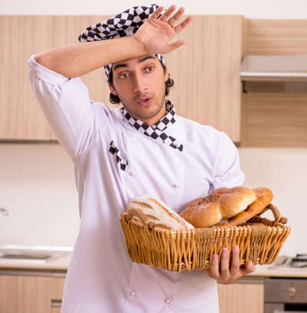 Young male baker working in kitchenの写真素材