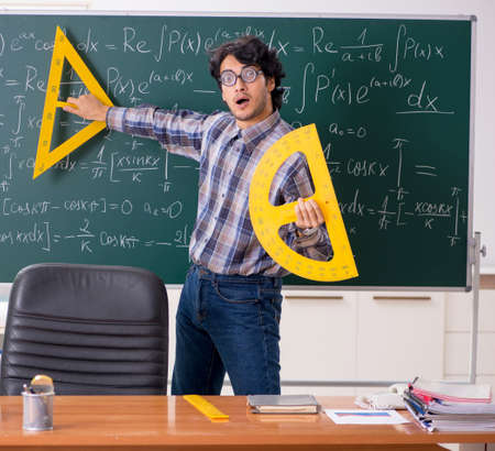 Funny male math teacher in the classroom