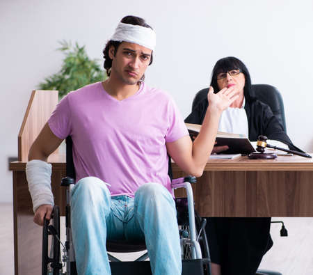 Disabled man consulting judge for damages litigationの写真素材