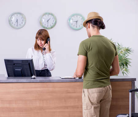 Young man at the hotel receptionの写真素材
