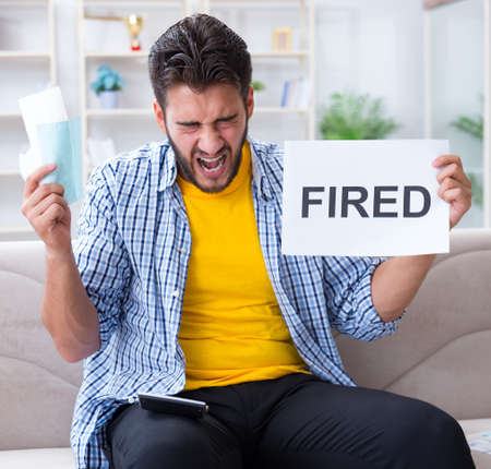 Unemployed man frustrated at bills he needs to payの写真素材