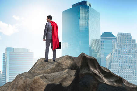 Superhero businessman on top of mountainの写真素材